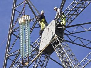 New insulators lifted into position